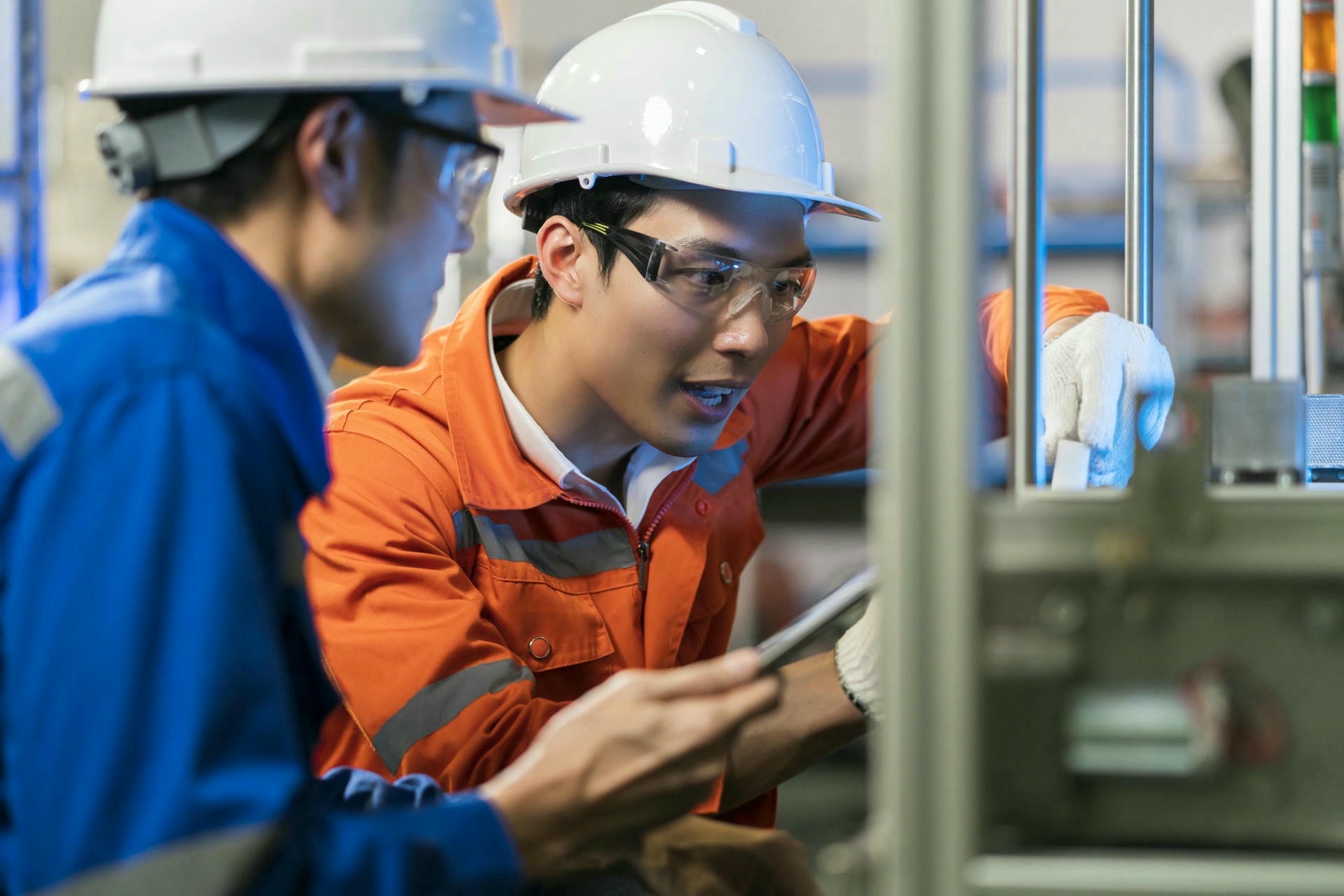 male asian engineer professional having discussion standing by machine factory two asian coworker brainstorm explaining solves process curcuit mother board machine scaled